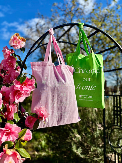 a green and pink bags from a metal arch