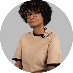 a woman with curly hair wearing glasses
