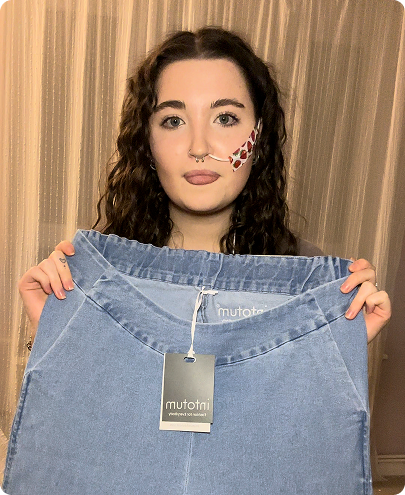 a woman holding up a shirt