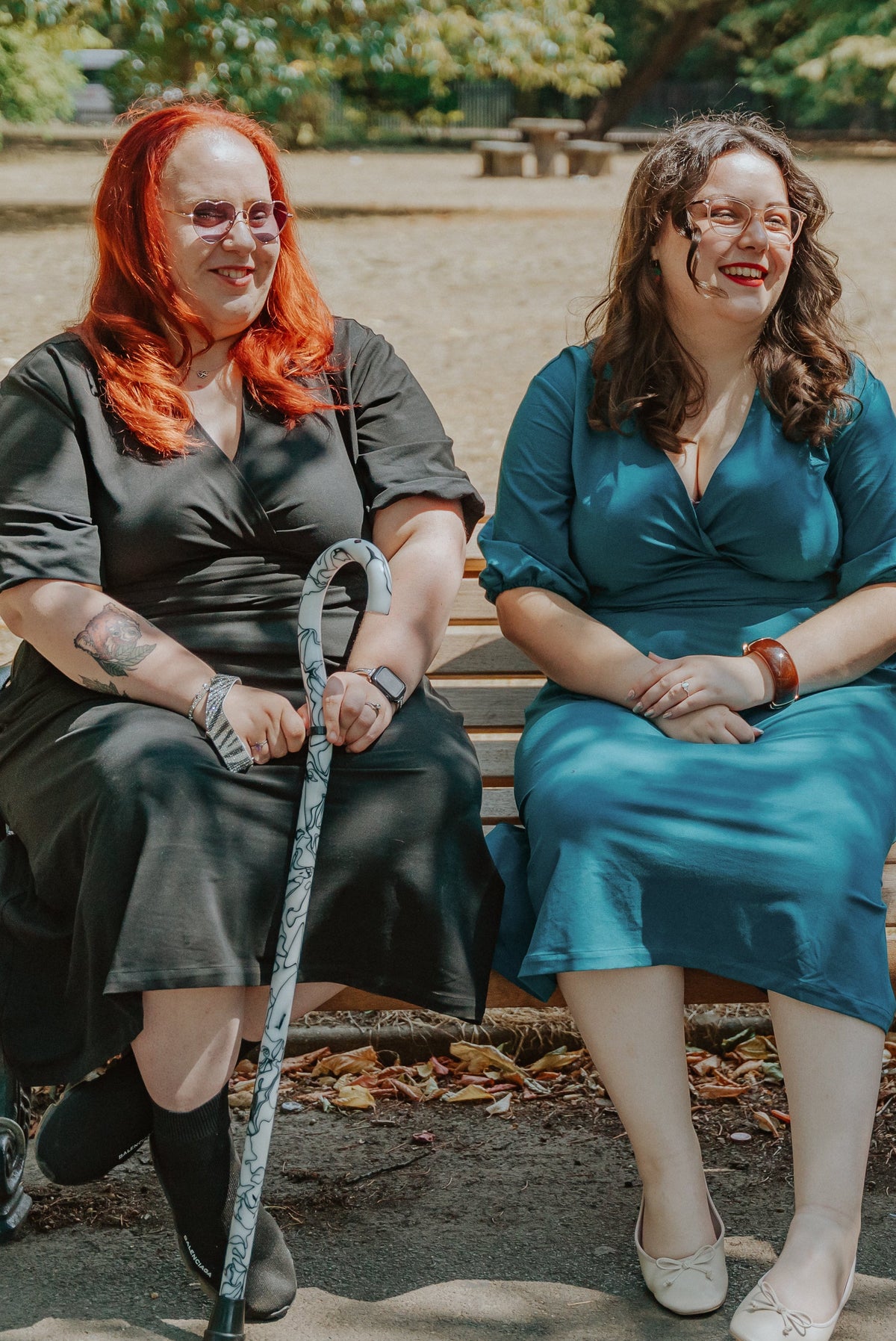 two women sitting on a bench