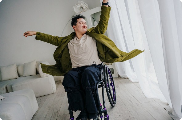 a man in a wheelchair with arms outstretched